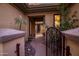 Private courtyard entry with wrought iron gate and desert landscaping at 40822 N Harbour Town Way, Anthem, AZ 85086