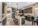 Modern kitchen with granite island, stainless steel appliances, and dark wood cabinets at 40822 N Harbour Town Way, Anthem, AZ 85086