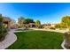 Large backyard with a grassy area, fountain, and pergola at 4142 E Ravenswood Dr, Gilbert, AZ 85298