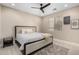 King-size bed in a well-lit bedroom with ceiling fan at 4142 E Ravenswood Dr, Gilbert, AZ 85298