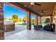 Covered patio with comfortable seating and views of the fountain and backyard at 4142 E Ravenswood Dr, Gilbert, AZ 85298