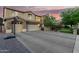 Two-story house with stone accents, a three-car garage and basketball court at 4142 E Ravenswood Dr, Gilbert, AZ 85298