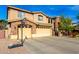 Two-story house with stone accents, a three-car garage and basketball court at 4142 E Ravenswood Dr, Gilbert, AZ 85298