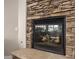 Stone fireplace with a modern glass front at 4142 E Ravenswood Dr, Gilbert, AZ 85298