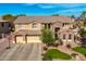 Two-story house with stone accents and three-car garage at 4142 E Ravenswood Dr, Gilbert, AZ 85298