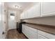 Bright laundry room with white cabinets, washer, dryer, and exterior access at 4142 E Ravenswood Dr, Gilbert, AZ 85298