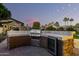 Modern outdoor kitchen with a built-in grill and wine cooler at 4142 E Ravenswood Dr, Gilbert, AZ 85298