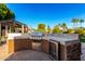 Outdoor kitchen with a built-in grill and refrigerator at 4142 E Ravenswood Dr, Gilbert, AZ 85298