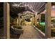 Elegant pathway under a pergola with string lights, leading to a relaxing patio area at 4142 E Ravenswood Dr, Gilbert, AZ 85298