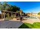 Relaxing pool area with pergola, firepit, and patio seating at 4142 E Ravenswood Dr, Gilbert, AZ 85298