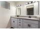 Updated bathroom with double vanity and gray countertops at 4316 E La Puente Ave, Phoenix, AZ 85044