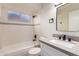 Clean bathroom with single vanity, shower/tub combo, and gray countertops at 4316 E La Puente Ave, Phoenix, AZ 85044