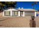 Charming single story home with gray garage door and well-maintained landscaping at 4316 E La Puente Ave, Phoenix, AZ 85044