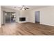 Spacious living area with wood-look flooring and a fireplace at 4316 E La Puente Ave, Phoenix, AZ 85044