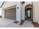 Front entry with brown door and garage at 4415 N Sidney St, Buckeye, AZ 85396