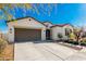 Single-story home with brown garage door and landscaping at 4415 N Sidney St, Buckeye, AZ 85396