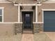 Close up of the home's entrance and brick walkway, framed by stone pillars and metal gate at 4727 N 177Th Dr, Goodyear, AZ 85395