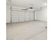 Spacious two-car garage featuring a white garage door and concrete floor at 4727 N 177Th Dr, Goodyear, AZ 85395