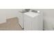 Well-lit laundry area features modern, matching washer and dryer units at 4727 N 177Th Dr, Goodyear, AZ 85395