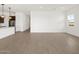 Bright living room featuring wood-look tile floors and a seamless transition to the modern kitchen at 4727 N 177Th Dr, Goodyear, AZ 85395