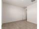 Simple bedroom with tile floors and a door at 4806 S 110Th Ave, Tolleson, AZ 85353