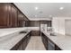 Modern kitchen with dark wood cabinets and granite countertops at 4806 S 110Th Ave, Tolleson, AZ 85353