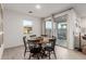 Bright dining area with round table and six chairs near sliding glass doors at 5644 W Jackalope Ln, Laveen, AZ 85339