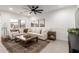 Bright and airy living room featuring a sectional sofa and large windows at 5644 W Jackalope Ln, Laveen, AZ 85339