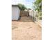 Side yard with a partial view of the fence and a dog at 6025 S 13Th St, Phoenix, AZ 85042