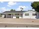 White single story home with carport and landscaped yard at 6732 E Culver St, Scottsdale, AZ 85257