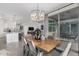 Open concept dining room with wood table and view into kitchen at 6843 W Samantha Way, Laveen, AZ 85339