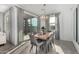 Bright dining room with a wood table and gray chairs, near sliding doors at 6843 W Samantha Way, Laveen, AZ 85339