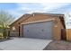 Modern home exterior with gray garage door and stone accents at 6843 W Samantha Way, Laveen, AZ 85339