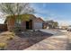 New construction home with gray garage door and rock landscaping at 6843 W Samantha Way, Laveen, AZ 85339