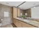 Modern bathroom with double sinks, marble countertops, and a large mirror at 7117 E Rancho Vista Dr # 4005, Scottsdale, AZ 85251