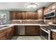 Modern kitchen with dark wood cabinets and stainless steel appliances at 7214 N 35Th Ave, Phoenix, AZ 85051