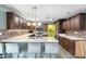 Modern kitchen with dark wood cabinets and a breakfast bar at 7214 N 35Th Ave, Phoenix, AZ 85051