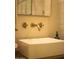 Chic bathroom with a sleek vessel sink and gold fixtures at 7301 E Claremont St, Scottsdale, AZ 85250