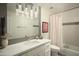 Modern bathroom with white vanity, marble countertop, and gray tile at 7301 E Claremont St, Scottsdale, AZ 85250