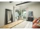 Main bedroom with arched windows and a large mirror at 7301 E Claremont St, Scottsdale, AZ 85250