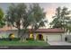 Single-story home with a red tile roof and arched entryways, nestled on a landscaped lot at 7301 E Claremont St, Scottsdale, AZ 85250