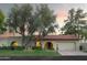 Spanish style home with red tile roof and lush landscaping at 7301 E Claremont St, Scottsdale, AZ 85250