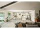 Modern kitchen with white cabinets, a large island, and glass-top dining table at 7301 E Claremont St, Scottsdale, AZ 85250