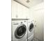 Bright laundry room, complete with washer, dryer, and upper cabinets at 7301 E Claremont St, Scottsdale, AZ 85250