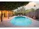 Stunning kidney shaped pool with surrounding patio and seating at 7301 E Claremont St, Scottsdale, AZ 85250