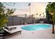 Inviting kidney-shaped pool with lounge chairs and string lights at 7301 E Claremont St, Scottsdale, AZ 85250