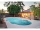 Inviting kidney-shaped pool with pergola and string lights at 7301 E Claremont St, Scottsdale, AZ 85250