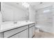 Bathroom featuring double sinks, shower and tub combo, and white cabinets at 7820 E Quintana Ave, Mesa, AZ 85212