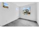 This bedroom features neutral carpet and plenty of sunlight from large windows at 7820 E Quintana Ave, Mesa, AZ 85212