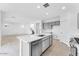 Bright, open-concept living space connected to the kitchen, featuring sleek flooring and recessed lighting at 7820 E Quintana Ave, Mesa, AZ 85212